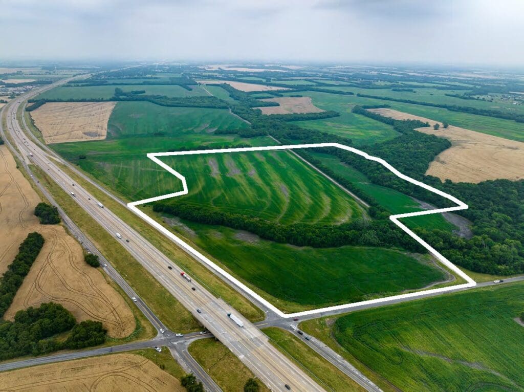 Aerial view of bordered farmland by highway